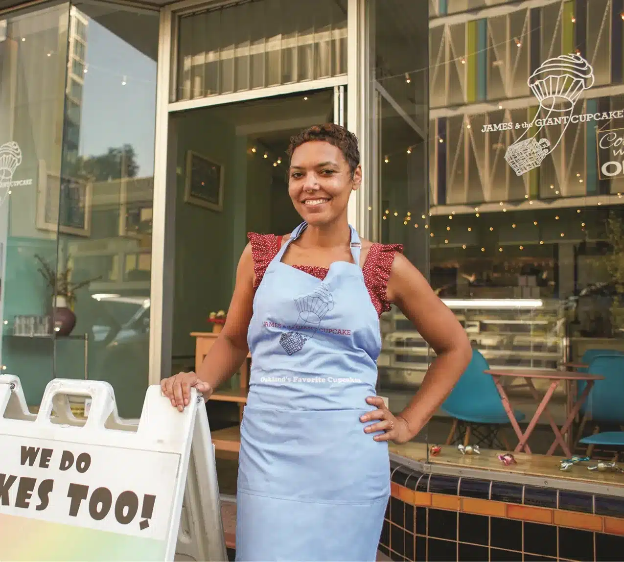 Small business owner in front of their shop